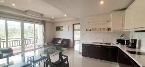 a kitchen with a glass table and a counter top at Khanom Beach Residence For rent monthly in Khanom