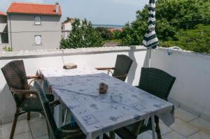 a table and chairs on the balcony of a house at Apartments Nadia Sokolić in Nerezine +38 photos