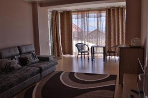 a living room with a couch and a table and chairs at Panorama in Cholpon-Ata