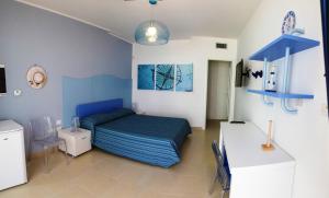a bedroom with a bed and a desk in it at La Corte di Leuca Residence in Leuca +54 photos