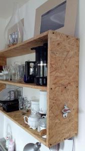 a wooden cabinet with dishes on a kitchen shelf at ART mieszkanie blisko dworca PKP Walbrzych Miasto in Wałbrzych