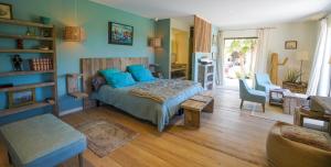 a bedroom with a bed and a living room at villa Sant-Anna in Saint-Tropez