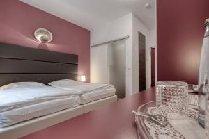 Postel nebo postele na pokoji v ubytování Hotel l'adresse garni