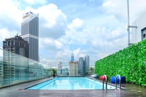 a swimming pool on the roof of a building at Pacific Express Hotel Central Market Kuala Lumpur in Kuala Lumpur