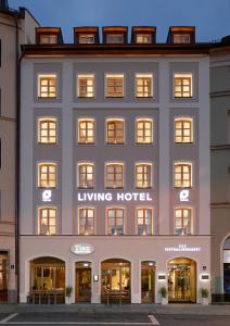 a large building with a clock on the front of it at Living Hotel Das Viktualienmarkt in Munich
