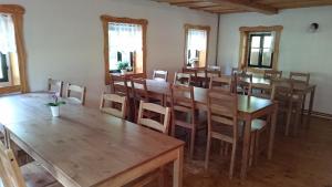 a dining room with wooden tables and chairs at Chalupa pro děti in Drnovec