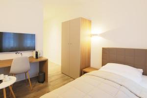 Postel nebo postele na pokoji v ubytování Hotel Work Life Residence am Bahnhof