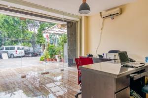 an office with a desk with a laptop on it at RedDoorz At Tebet Barat 2 in Jakarta