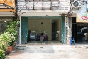 an entrance to a building with a car parked at RedDoorz At Tebet Barat 2 in Jakarta