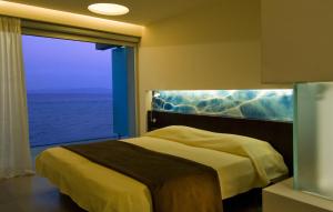 a hotel room with a bed and a window at Kos Aktis Art Hotel in Kos