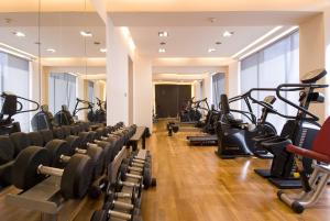 a gym with rows of treadmills and machines at Kos Aktis Art Hotel in Kos