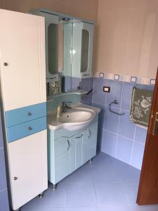 a blue bathroom with a sink and a mirror at Lake view apartment! 200m2 in Pogradec +18 photos