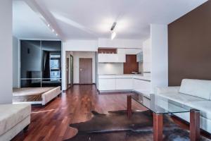 a living room with a couch and a table at Apartament Gdański in Warsaw