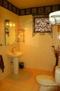 a bathroom with a sink and a toilet at Asian Jewel Boutique Hotel in Hikkaduwa