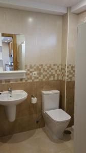 a bathroom with a toilet and a sink at APARTAMENTOS EL SOLO in Santillana del Mar +53 photos