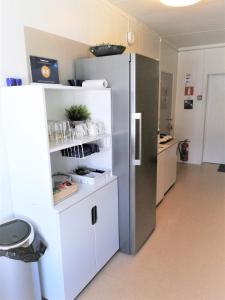 a kitchen with a large refrigerator in a room at Løvheim Gjestehus - Anneks in Sauland