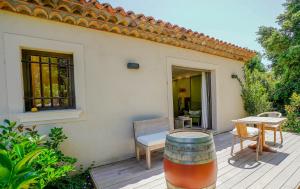 a patio with a table and a wine barrel at villa Sant-Anna in Saint-Tropez