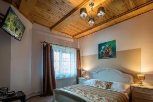 a bedroom with a bed and a wooden ceiling at Apartments - BOWLINGHORKA sk in Poprad