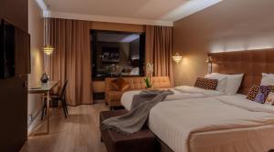 a hotel room with two beds and a desk at Radisson Blu Marina Palace Hotel, Turku in Turku