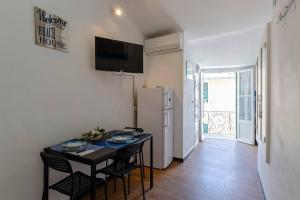 a small kitchen with a table and a refrigerator at ALTIDO Flat for 4, close to 2 Beaches, Sestri Levante in Sestri Levante