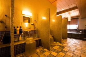 a bathroom with a shower and a toilet and a sink at Dormy Inn Premium Kyoto Ekimae Natural Hot Spring in Kyoto