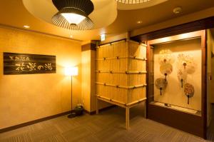 a room with a display case and a lamp at Dormy Inn Premium Kyoto Ekimae Natural Hot Spring in Kyoto