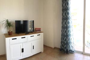 a tv on top of a white cabinet in a room at Charco Las Damas in Playa de San Juan