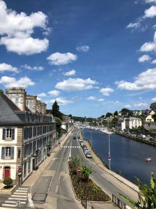 a view of a city with a river and buildings at hotel de Croix in Morlaix