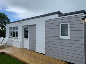 a small shed with a wooden deck at Out Bac in Saint Breward