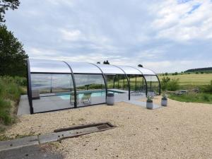 a glass house with a swimming pool in it at Country house in the Ardennes with Schwimmbad in Warempage