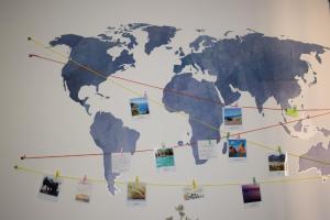 a map of the world hanging on a wall at Casa di Eugenia in Loceri