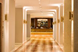 a hallway of a hotel with a checkered floor at Grand Hotel Terme Sirmione in Sirmione