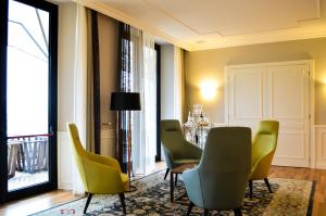 a living room with chairs and a table and a window at Grand Hotel Terme Sirmione in Sirmione