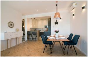 a dining room and kitchen with a table and chairs at Stylish - Centre Apartment Theatre View in Rijeka