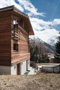 a wooden house with mountains in the background at Chalet Sperling in Saas-Fee