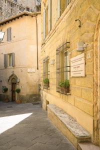 a building with a sign on the side of it at Albergo Tre Donzelle in Siena