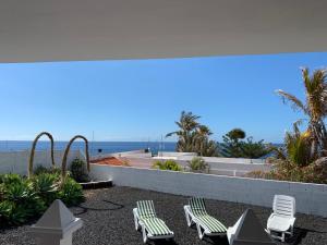 a patio with chairs and a view of the ocean at Villa Playa La Salemera - La Palma in Malpaíses