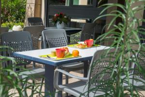 uma mesa azul com dois pratos de fruta em IBIS Budget Aix en Provence Est Le Canet em Meyreuil