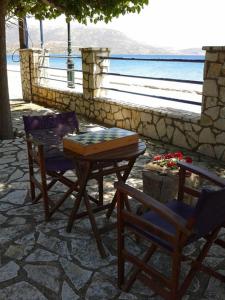 a table and two chairs and a table and a table and chairs at Holiday Tolofona Beach in Erateini