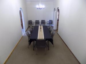 uma sala de conferências com uma mesa longa e cadeiras em Haka Hana B&B The Farm House em Port Elizabeth