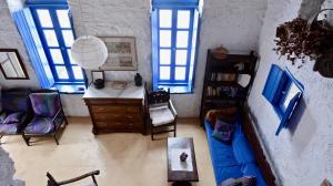 a living room with blue windows and a blue couch at Villa Clio Serifos in Serifos Chora