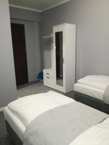 
A bed or beds in a room at City Rooms Szczecin

