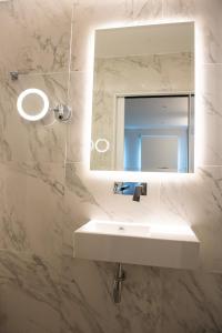 a bathroom with a sink and a mirror at NOX West Hampstead in London