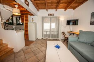 a living room with a couch and a table at Ionian Seaview apartments in Syvota +14 photos