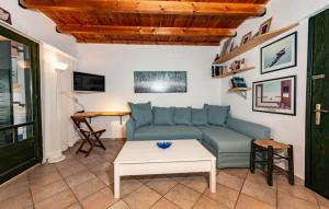 a living room with a blue couch and a table at Ionian Seaview apartments in Syvota