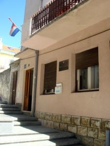 a building with a flag on the side of it at Apartments Popov in Crikvenica