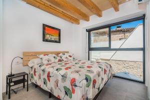 a bedroom with a bed and a large window at CASA OASIS in Pollença +20 photos