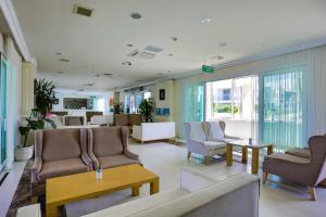 a waiting room with couches and chairs and tables at Dragut Point South Hotel-All Inclusive in Turgutreis