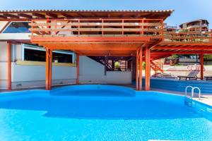 a swimming pool with a pavilion on top of the water at Estate Kares in Tílisos