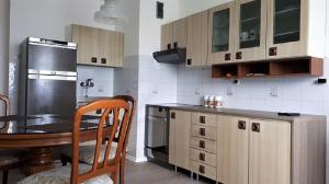 a kitchen with a table and a refrigerator at Apartma Lilu in Koper